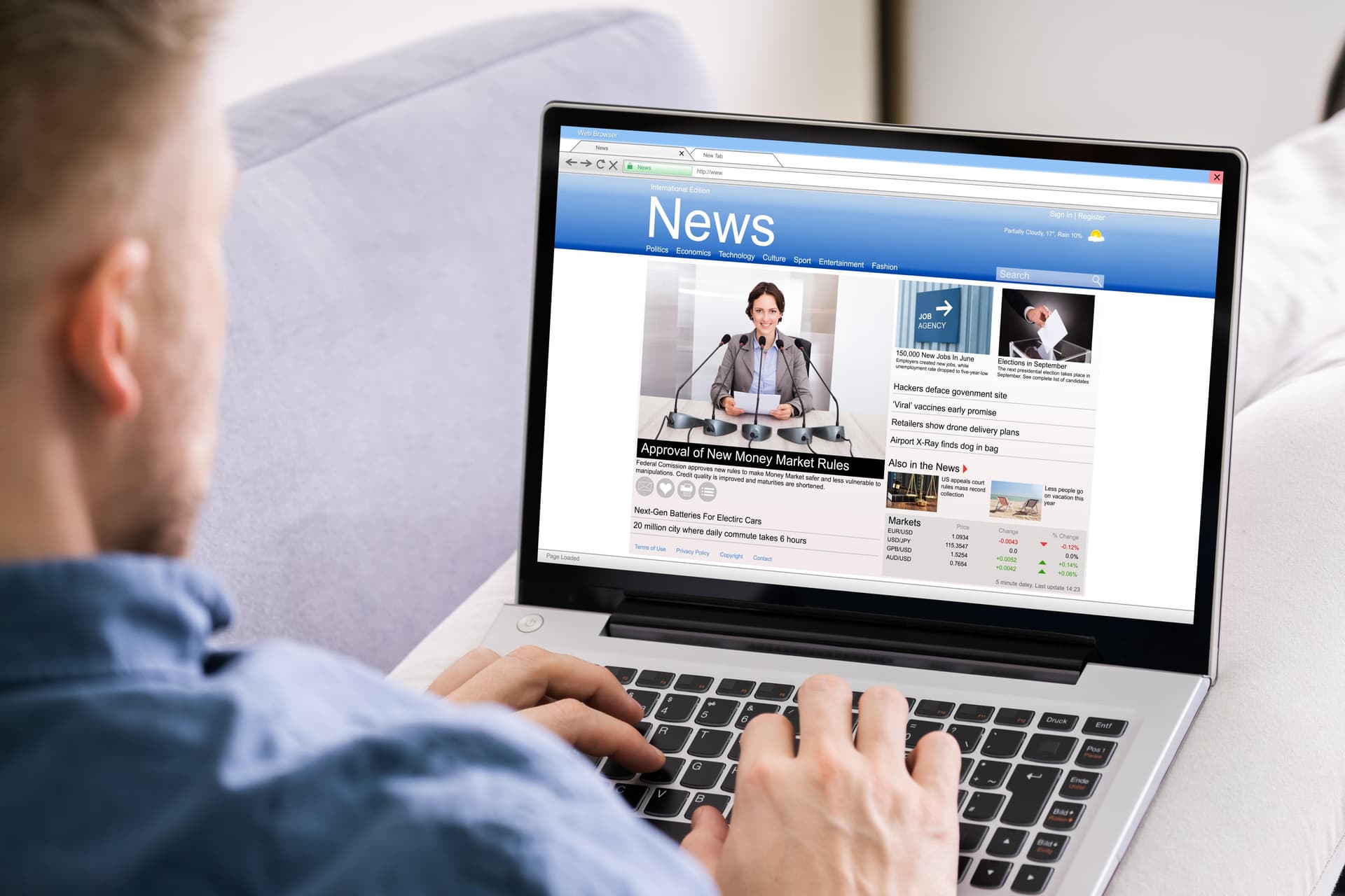 man reading news on laptop