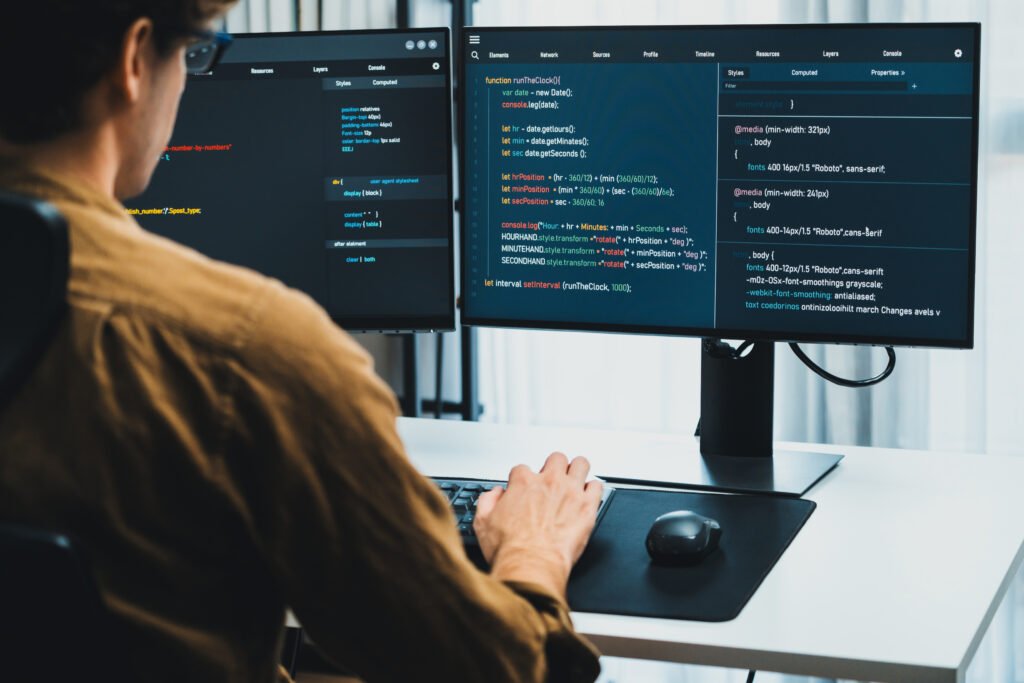 IT developer working online software development on pc monitors